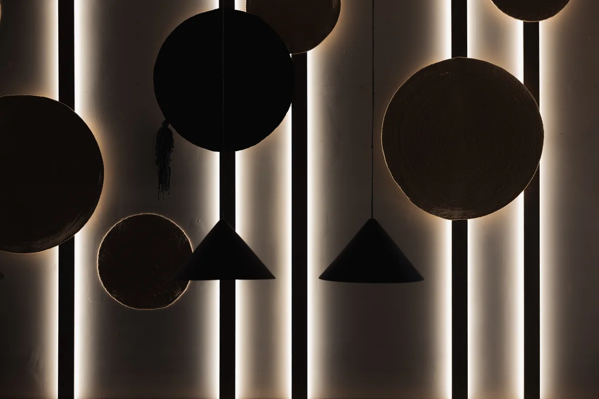 The Wok — circular wall details and pendant lights at night